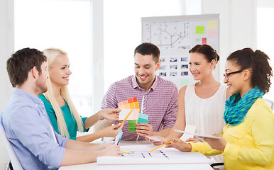 Image showing smiling interior designers working in office