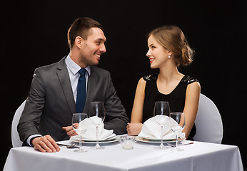 Image showing smiling couple looking at each other at restaurant