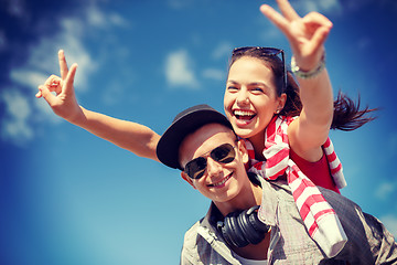 Image showing smiling teenagers in sunglasses having fun outside