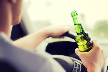 Image showing man drinking alcohol while driving the car