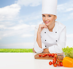 Image showing smiling female chef with vegetables