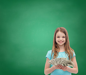 Image showing smiling little girl with dollar cash money