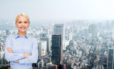 Image showing young smiling businesswoman with crossed arms