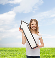 Image showing smiling little girl with blank arrow pointing up