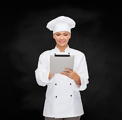 Image showing smiling female chef with tablet pc computer