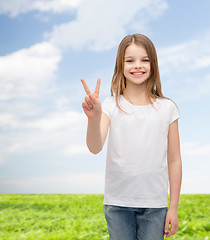 Image showing little girl in white t-shirt showing peace gesture