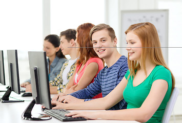 Image showing smiling student with computer studying at school