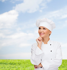 Image showing smiling female chef dreaming