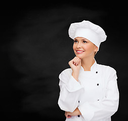 Image showing smiling female chef dreaming