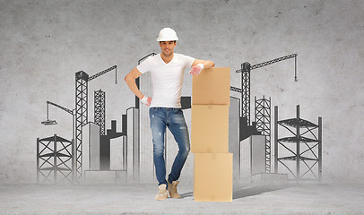 Image showing man in helmet with tower of cardboard boxes