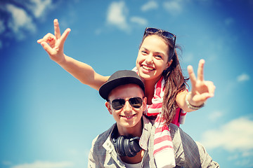 Image showing smiling teenagers in sunglasses having fun outside