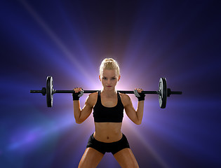 Image showing sporty woman exercising with barbell