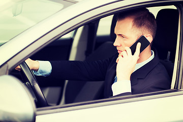 Image showing man using phone while driving the car