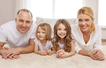 Image showing parents and two girls lying on floor at home