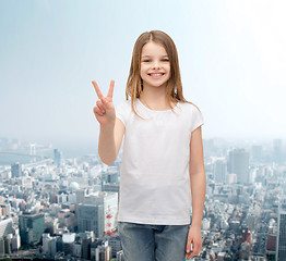 Image showing little girl in white t-shirt showing peace gesture