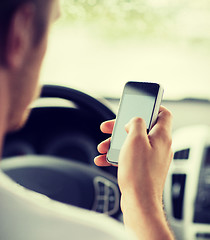 Image showing man using phone while driving the car