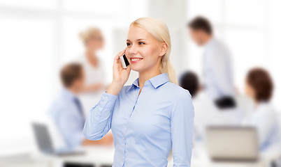 Image showing young smiling businesswoman with smartphone