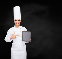 Image showing smiling female chef with tablet pc blank screen