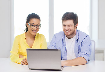 Image showing two smiling people with laptop in office