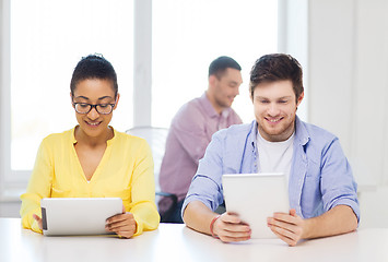 Image showing smiling team with tablet pc computers at office