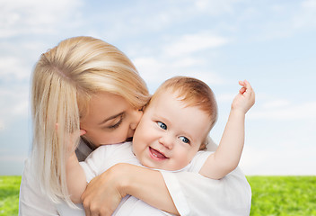 Image showing happy mother kissing smiling baby