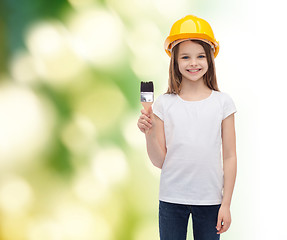 Image showing smiling little girl in helmet with paint roller