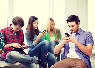 Image showing students looking into devices at school