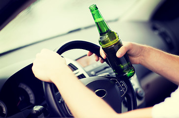 Image showing man drinking alcohol while driving the car