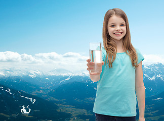 Image showing smiling little girl giving glass of water