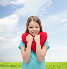 Image showing smiling little girl with red heart