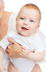 Image showing close up of mother holding smiling baby