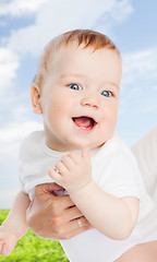 Image showing close up of mother holding smiling baby