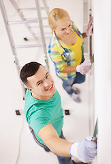 Image showing smiling couple doing renovations at home