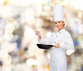 Image showing smiling female chef with pan and spoon