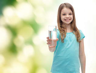 Image showing smiling little girl giving glass of water