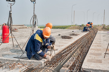 Image showing Workers do fittings binding