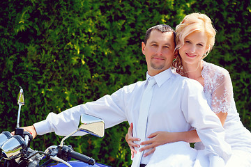 Image showing beautiful young wedding couple on motorcycle