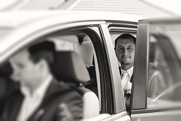 Image showing groom sitting in a car