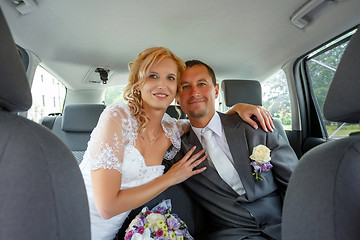 Image showing beautiful young wedding couple in car