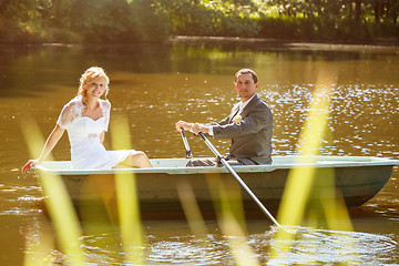 Image showing Young just married bride and groom on boat