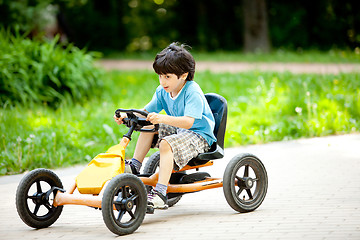 Image showing boy rides a velomobile