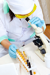 Image showing medical scientist with microscope