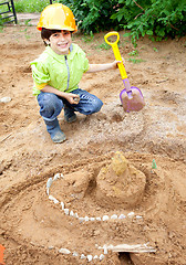 Image showing boy builder in a protective helmet