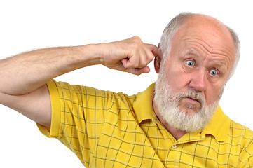 Image showing goofy bald senior man's picking his ear