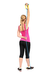 Image showing Female triceps extention exercise using rubber resistance band