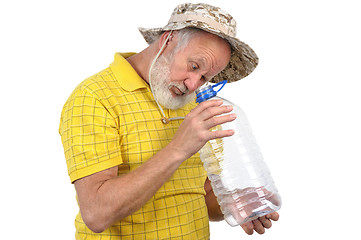 Image showing senior man looking into empty bottle