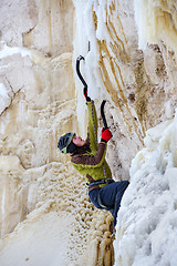 Image showing Young man climbing the ice