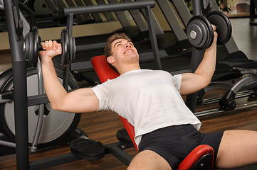 Image showing Young man doing Dumbbell Incline Bench Press workout in gym