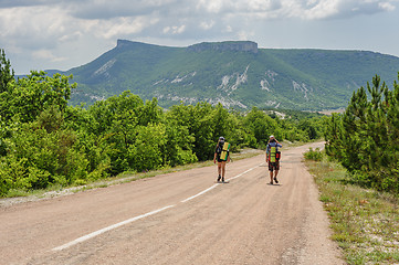 Image showing Two hiking people on the road