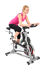 Image showing young woman doing indoor biking exercise
